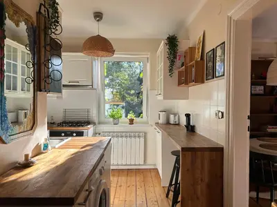 a kitchen with a wooden counter and a window at Apartament na starej Krowodrzy in Kraków