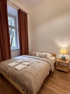 a bedroom with a large bed with two towels on it at Apartament Stare Miasto in Kraków