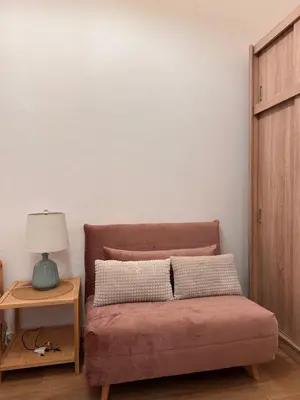 a bedroom with a bed and a table with a lamp at Apartament Stare Miasto in Kraków
