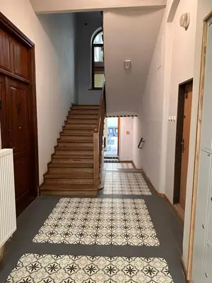 a hallway with a staircase and a tile floor at Apartament Stare Miasto in Kraków