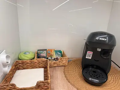 a black coffee maker sitting on a table with a basket at Apartament Stare Miasto in Kraków