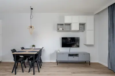 a dining room with a table and chairs at Park Krowoderski Comfort Apartment by BookingHost in Kraków