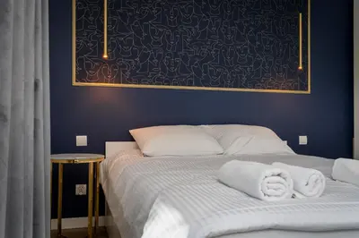 a bedroom with a bed with two towels on it at Park Krowoderski Comfort Apartment by BookingHost in Kraków