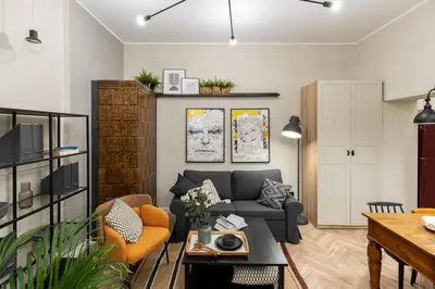 a living room with a gray couch and orange chairs at Nobel Apartment - BEST LOCATION! in Kraków