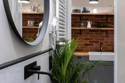 a bathroom with a mirror and a sink at Nobel Apartment - BEST LOCATION! in Kraków