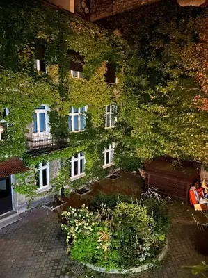 a building with ivy growing on the side of it at Nobel Apartment - BEST LOCATION! in Kraków