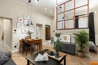 a living room with a table and a dining room at Nobel Apartment - BEST LOCATION! in Kraków