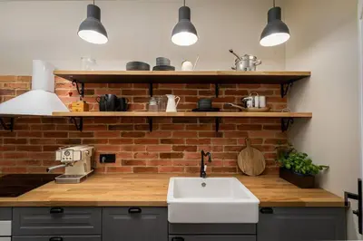 a kitchen with a sink and a brick wall at Nobel Apartment - BEST LOCATION! in Kraków
