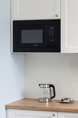 a microwave above a kitchen counter with a food processor at Modern Studio Kazimierz for 4 Guests only 1 km to Wawel Castle by Noclegi Renters in Kraków