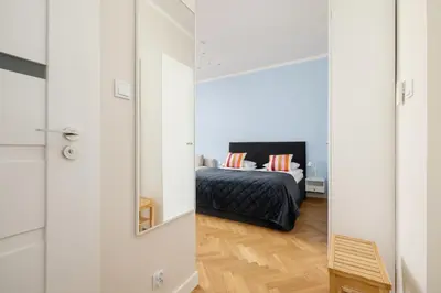 a bedroom with a bed and a mirror at Modern Studio Kazimierz for 4 Guests only 1 km to Wawel Castle by Noclegi Renters in Kraków