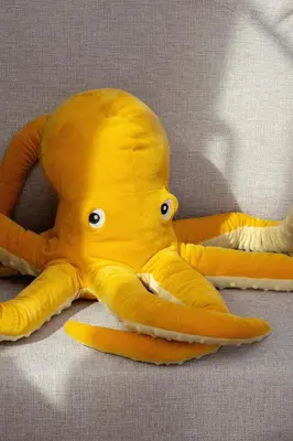 a yellow octopus is laying on the floor at Modern Studio Kazimierz for 4 Guests only 1 km to Wawel Castle by Noclegi Renters in Kraków