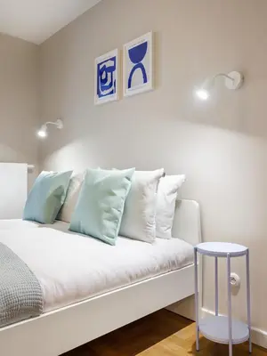 a white couch with pillows on it in a room at Tyzenhauz Apartments Vistula with Parking in Kraków