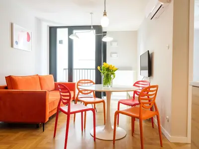 a living room with a table and chairs and a couch at Tyzenhauz Apartments Vistula with Parking in Kraków