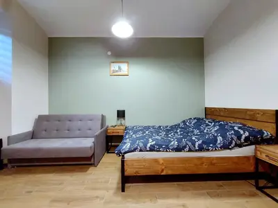 a bedroom with a bed and a couch at Krakowskim Szlakiem - OLD TOWN in Kraków