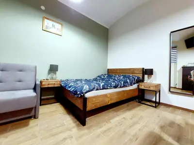 a bedroom with a bed and a chair at Krakowskim Szlakiem - OLD TOWN in Kraków