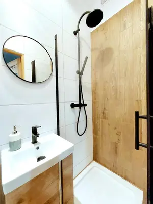 a bathroom with a sink and a shower with a mirror at Krakowskim Szlakiem - OLD TOWN in Kraków