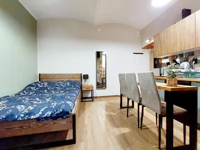 a bedroom with a bed and a table and chairs at Krakowskim Szlakiem - OLD TOWN in Kraków