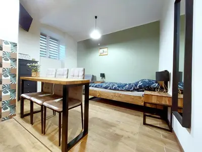 a room with a bed and a table and chairs at Krakowskim Szlakiem - OLD TOWN in Kraków