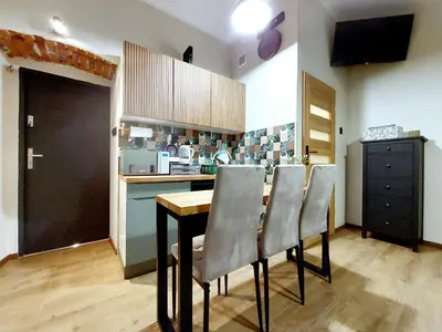 a kitchen with a table and chairs in a room at Krakowskim Szlakiem - OLD TOWN in Kraków