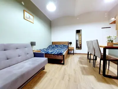 a living room with a bed and a dining table at Krakowskim Szlakiem - OLD TOWN in Kraków