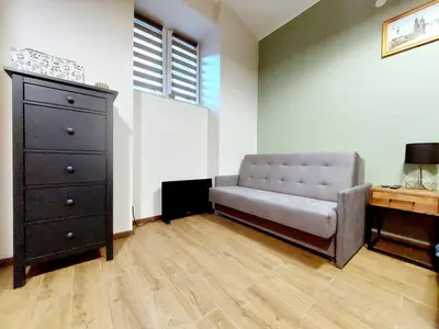a living room with a couch and a dresser at Krakowskim Szlakiem - OLD TOWN in Kraków