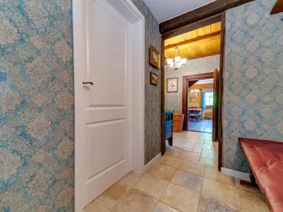 a hallway with a white door and blue wallpaper at Holiday Home Bastrówka by Interhome in Chrosna