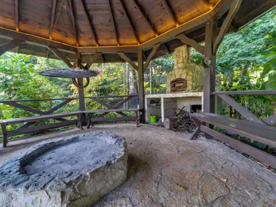 an outdoor area with a bench and a fireplace at Holiday Home Bastrówka by Interhome in Chrosna