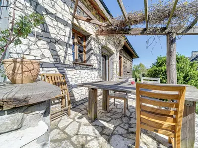 an outdoor patio with a wooden table and chairs at Holiday Home Jura dla Ciebie by Interhome in Cisowa