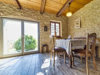 a dining room with a table and a large window at Holiday Home Jura dla Ciebie by Interhome in Cisowa