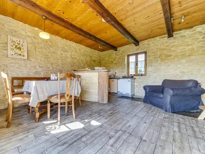 a room with a table and chairs and a kitchen at Holiday Home Jura dla Ciebie by Interhome in Cisowa