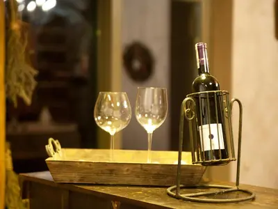 a bottle of wine and two wine glasses on a table at Holiday Home Moja Mała Toskania by Interhome in Cisowa