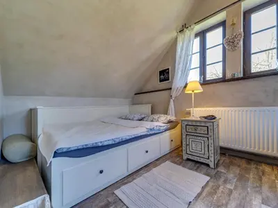 a bedroom with a white bed and a night stand at Holiday Home Moja Mała Toskania by Interhome in Cisowa