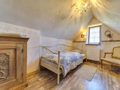 a bedroom with a bed and a chair at Holiday Home Moja Mała Toskania by Interhome in Cisowa