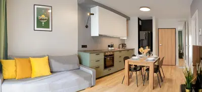 a living room with a couch and a table at Like Home Apartments in Kraków