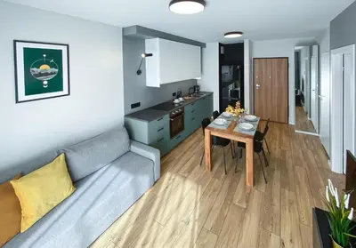 a living room with a couch and a table at Like Home Apartments in Kraków