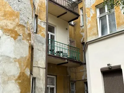 a building with a balcony on the side of it at St Gertruda Apartment Free Parking CityBeat#2 in Kraków