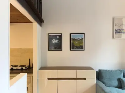 a living room with three pictures on the wall at St Gertruda Apartment Free Parking CityBeat#2 in Kraków