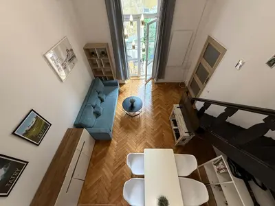 an overhead view of a living room with a table and chairs at St Gertruda Apartment Free Parking CityBeat#2 in Kraków