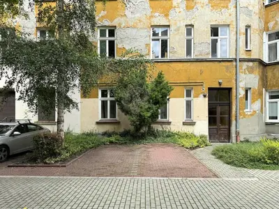an old building with a car parked in front of it at St Gertruda Apartment Free Parking CityBeat#2 in Kraków