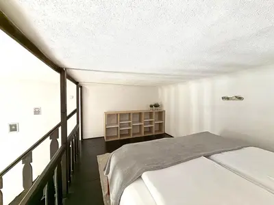 a bedroom with two beds and a balcony at St Gertruda Apartment Free Parking CityBeat#2 in Kraków