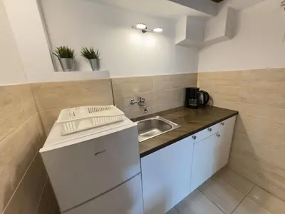 a small kitchen with a sink and a counter at St Gertruda Apartment Free Parking CityBeat#2 in Kraków