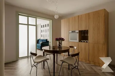 a kitchen and dining room with a table and chairs at Sage Apartment in Kraków