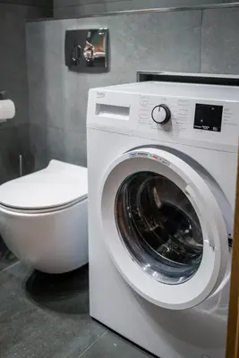 a washing machine and a toilet in a bathroom at GH Luxury Apartment in Kraków