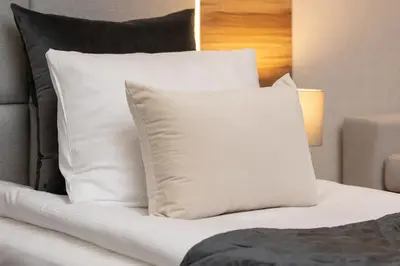 a white pillow sitting on top of a bed at Classy Cracow Apartments Rakowicka by Noclegi Renters in Kraków