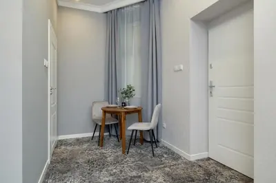 a room with a table and two chairs and a window at Classy Cracow Apartments Rakowicka by Noclegi Renters in Kraków