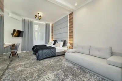 a living room with a bed and a couch at Classy Cracow Apartments Rakowicka by Noclegi Renters in Kraków