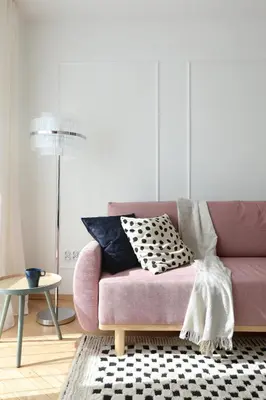 a pink couch with a black and white pillow on it at Beautiful & Cozy Apartment next to Main Market in Kraków
