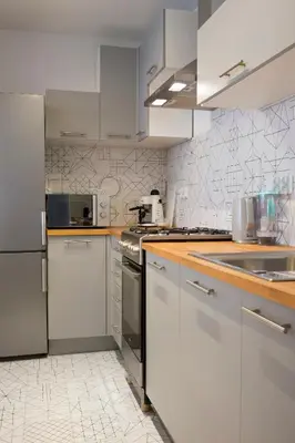 a kitchen with white cabinets and stainless steel appliances at Beautiful & Cozy Apartment next to Main Market in Kraków