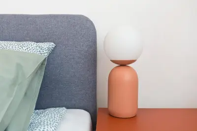 a lamp sitting on a table next to a bed at Beautiful & Cozy Apartment next to Main Market in Kraków