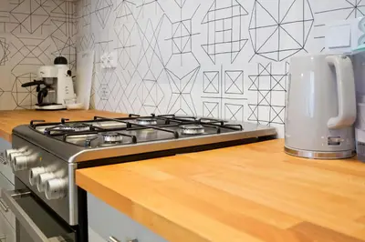 a stove top oven sitting on top of a kitchen counter at Beautiful & Cozy Apartment next to Main Market in Kraków